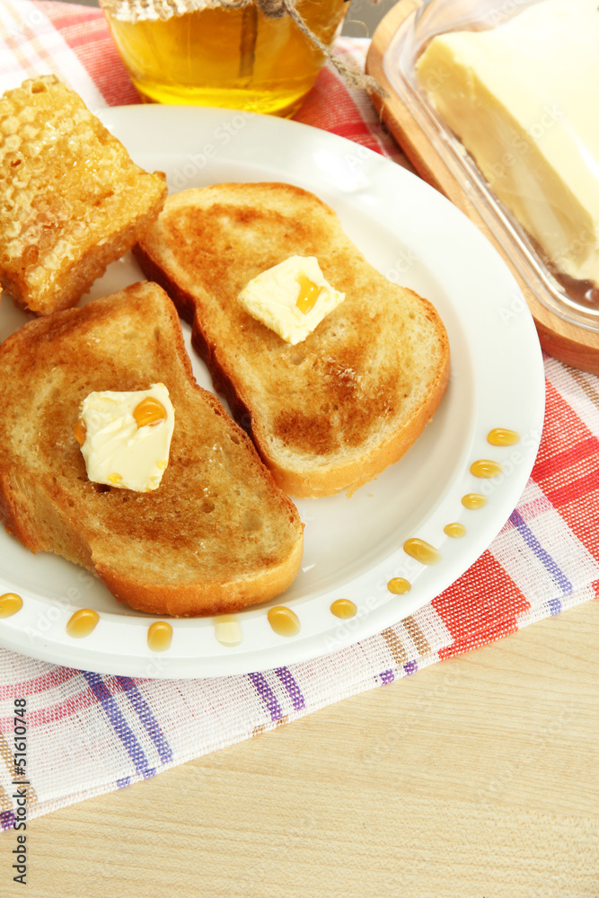 White bread toastwith honey on plate in cafe White bread toastwith honey on plate in cafe