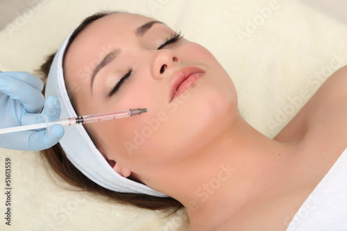 Young woman receiving plast...