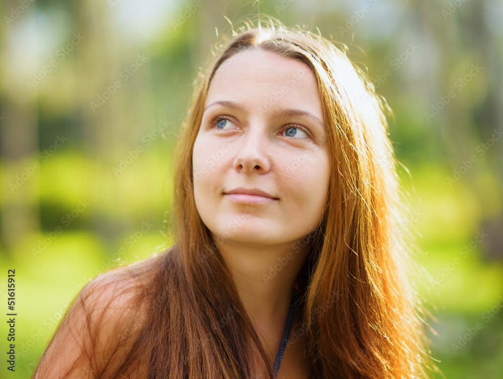 Fototapeta premium Portrait of young beautiful woman outdoors