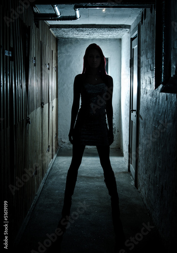 Beautiful girl in dark basement