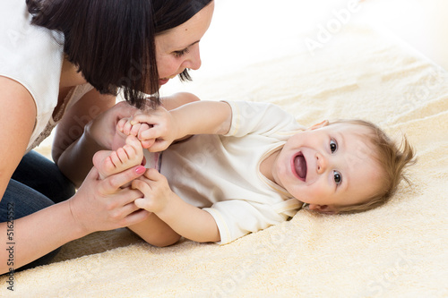 loving mother playing her baby