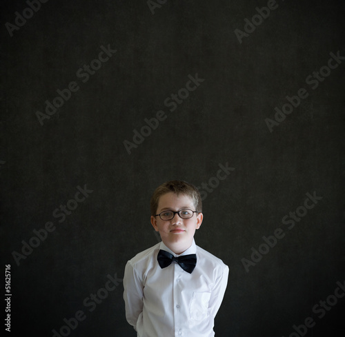 Hands behind back boy dressed up as business man