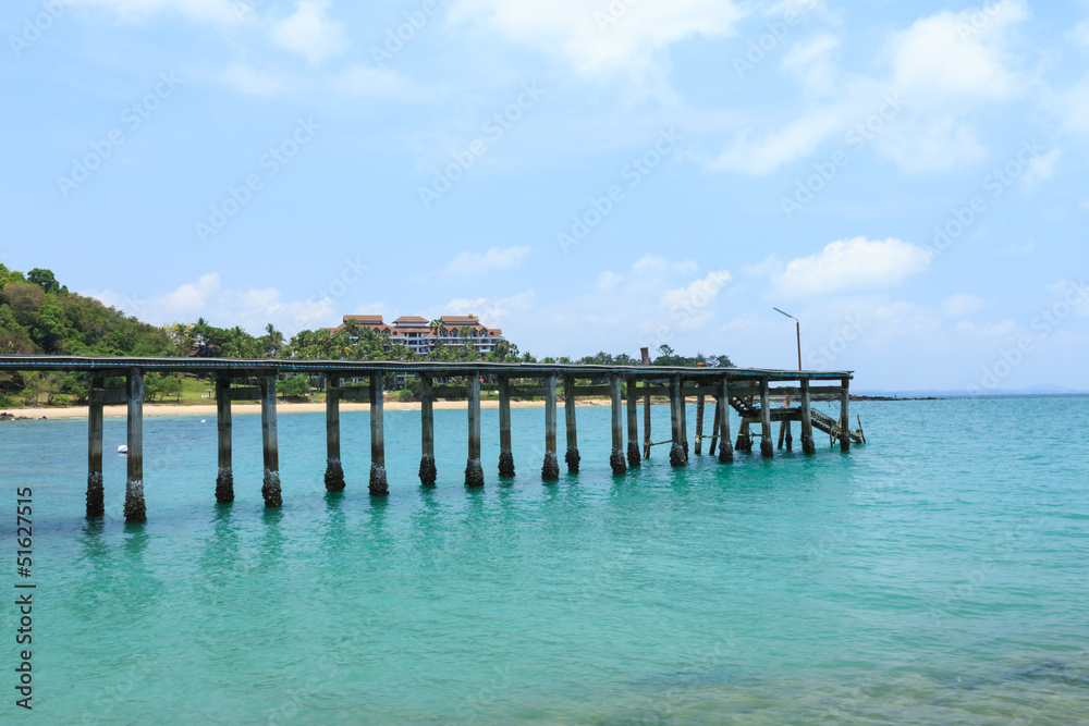 Wooden footbridge over the water near the beach