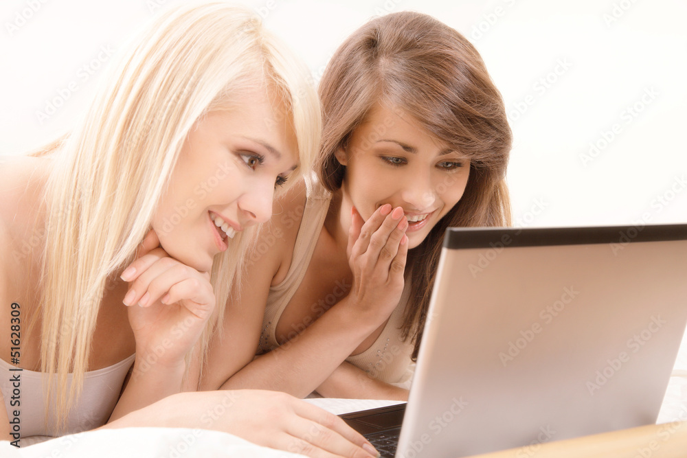 Two beautiful female friends browsing internet. Selective focus Two beautiful female friends browsing internet. Selective focus