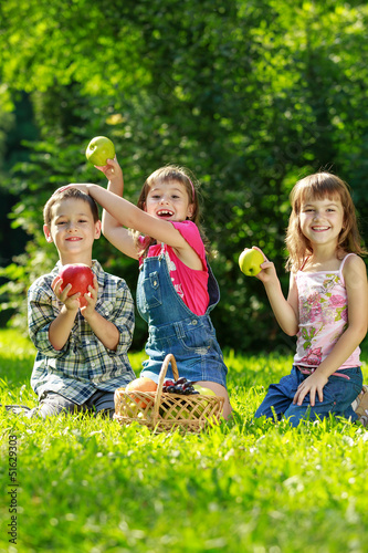 Three happy smiling child playing in park