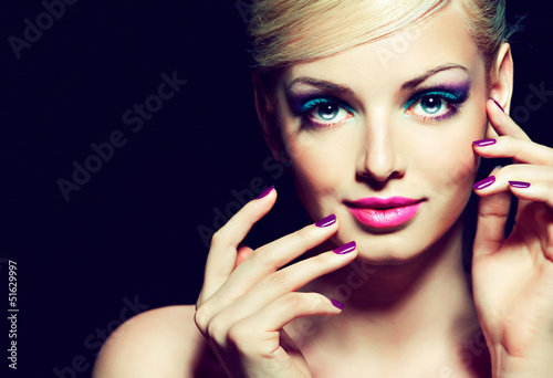 Blonde model with fashion make-up and violet manicure