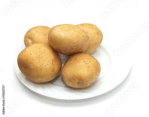 fresh potatoes on the plate on white background