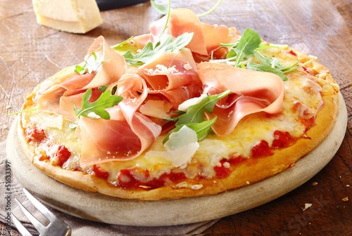 Italian pizza topped with prosciutto #51633397