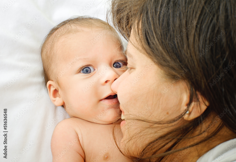 Mother kissed her little baby Mother kissed her little baby