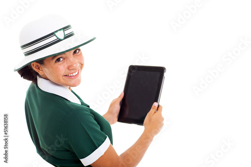 schoolgirl looking back holding tablet computer