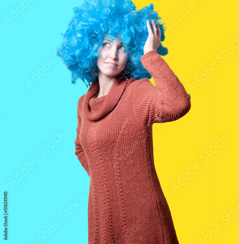 beautiful girl with curly blue wig and turtleneck