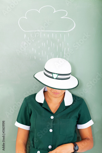 teenage school girl standing under the rain drawn on the chalkbo photo