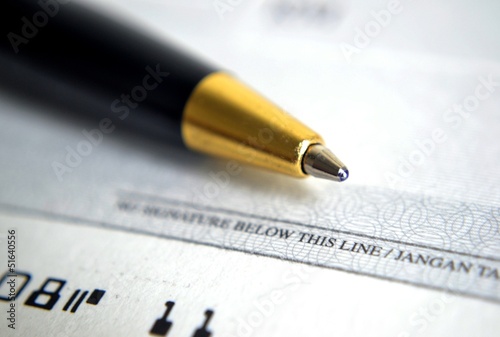 Close up on cheque with a pen