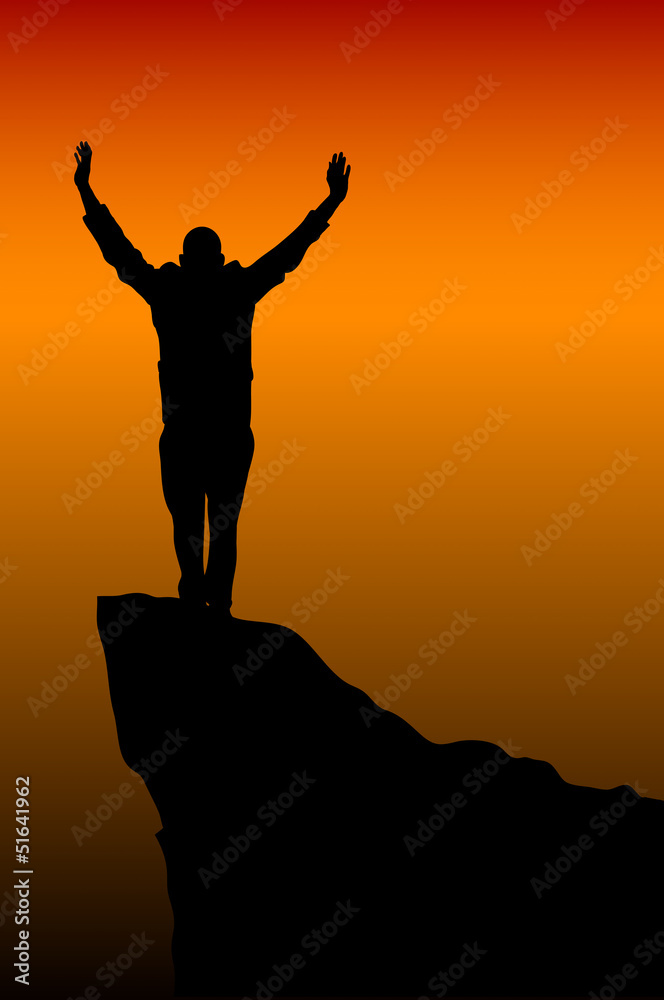 silhouette of a man at the top of the mountain against the sky