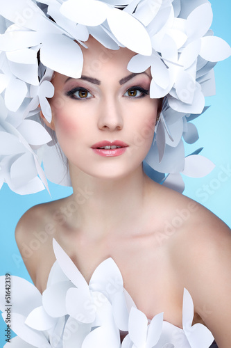 Wonderful girl in a hat from paper white butterflies on a blue  photo