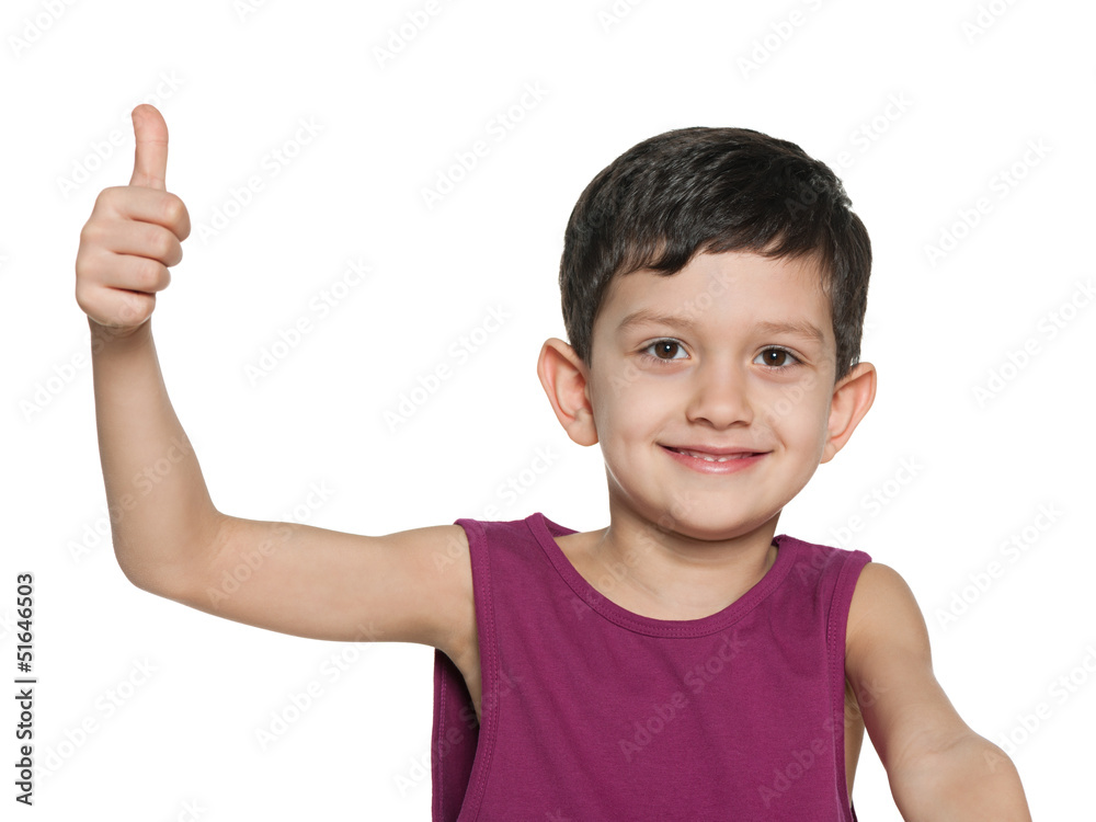 Closeup portrait of a young boy holds thumb up Closeup portrait of a young boy holds thumb up