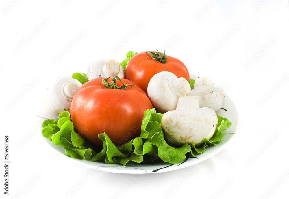 Tomatoes and mushrooms in a plate isolated on white Tomatoes and mushrooms in a plate isolated on white