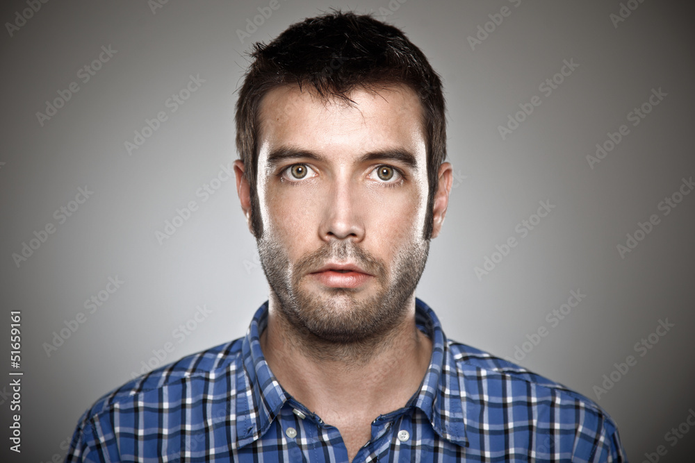 Portrait of a normal boy over grey background. Portrait of a normal boy over grey background.