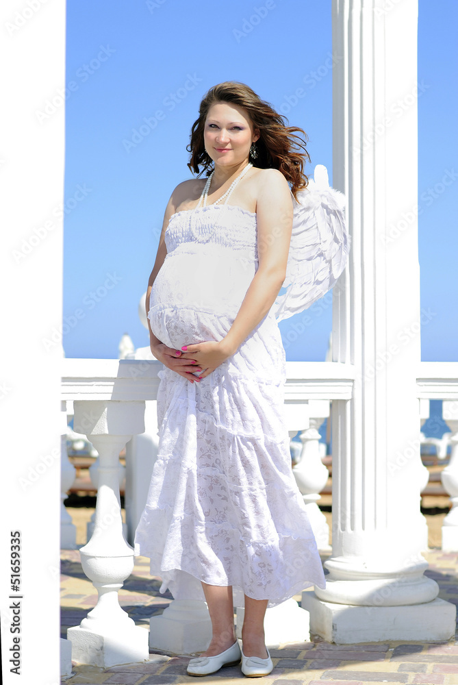 beautiful pregnant with a girl with wings