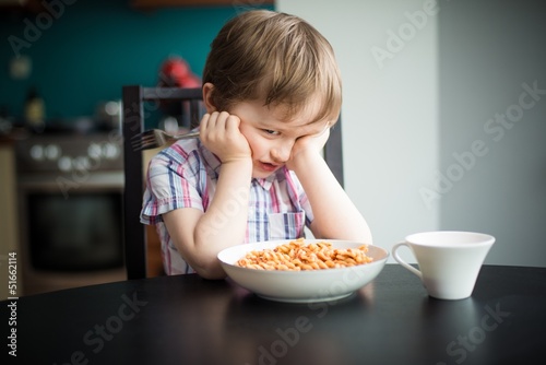 Obraz na płótnie Offended little boy refuses to eat dinner w salonie