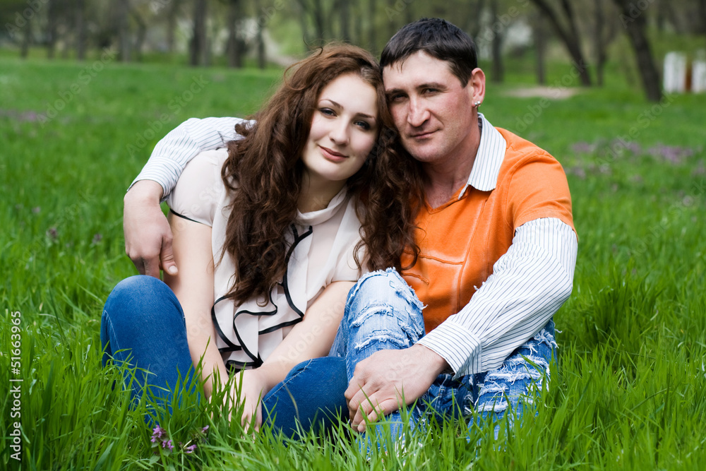 Couple sitting outdoors smiling Couple sitting outdoors smiling