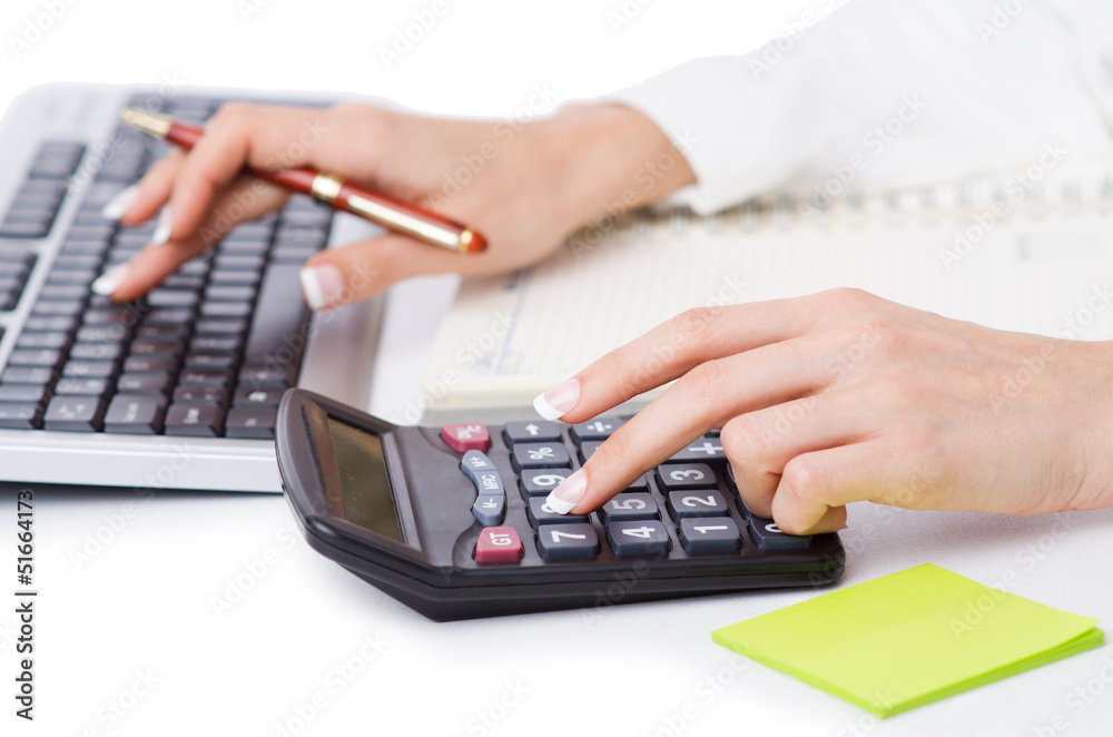 Hands working on the calculator Hands working on the calculator