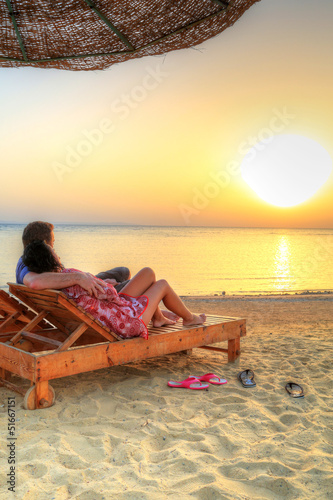 Couple in hug watching together sunrise over Red Sea in Egypt
