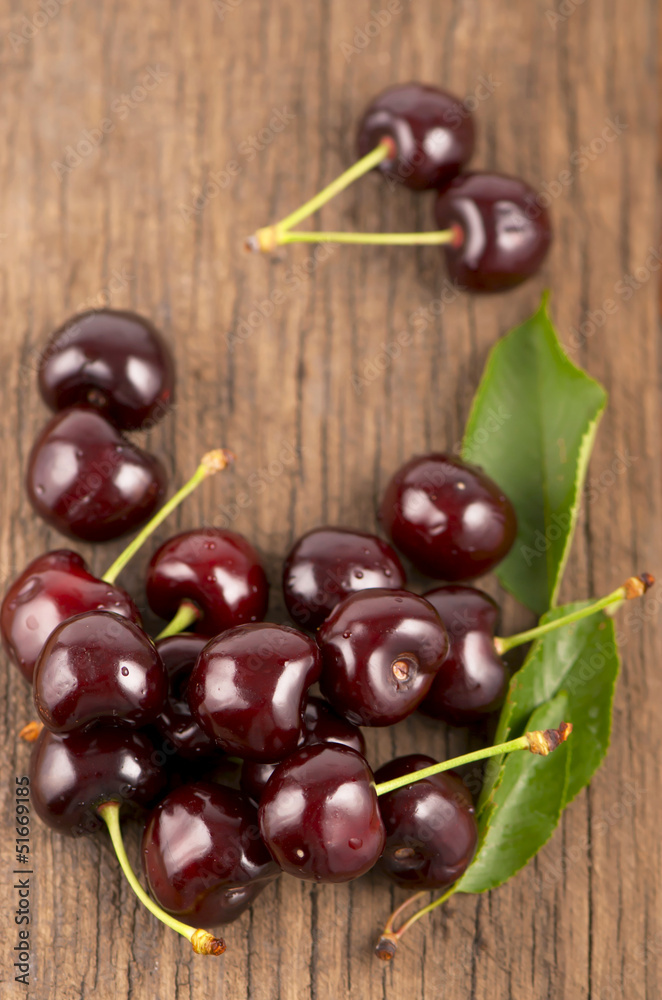 Red, ripe, juicy cherries on wooden boards Red, ripe, juicy cherries on wooden boards