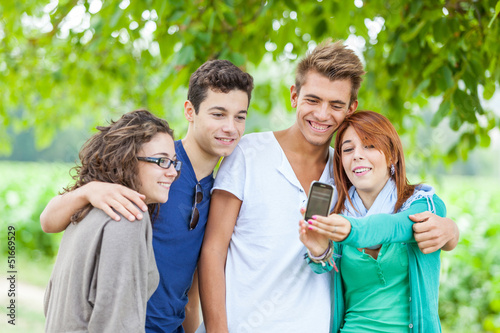 Group of Teenage Friends Taking Self Portraits with Mobile Phone