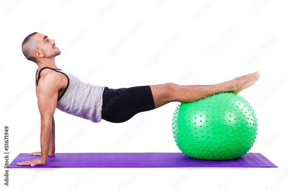 Man with swiss ball doing exercises on white Man with swiss ball doing exercises on white