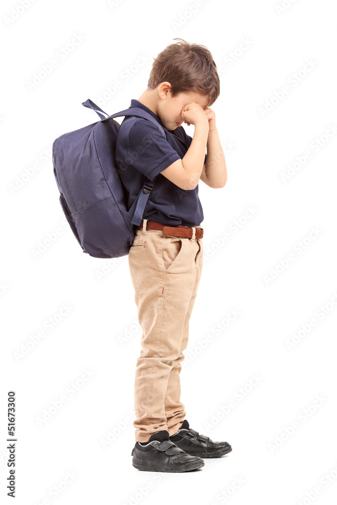 Full length portrait of a schoolboy crying