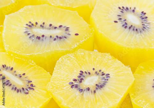 Full frame of yellow kiwi fruit sliced.