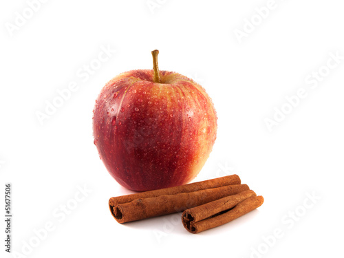 Isolated wet red apple with cinnamon on a white