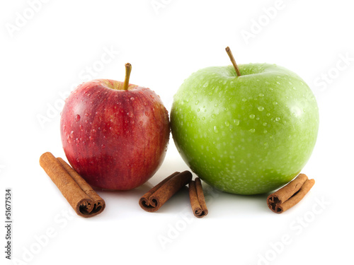 Isolated wet green and red apple with cinnamon