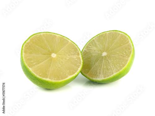 Isolated two halfs of green limes on a white