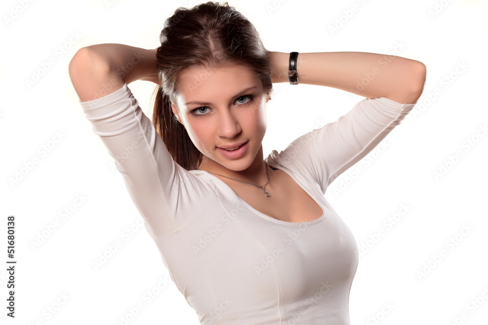 smiling blue-eyed teenager girl holding hair with a her hands smiling blue-eyed teenager girl holding hair with a her hands
