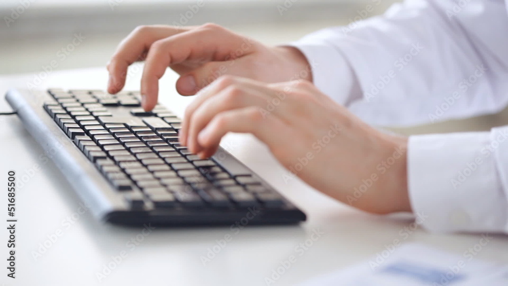 male doctor hands typing on keyboard