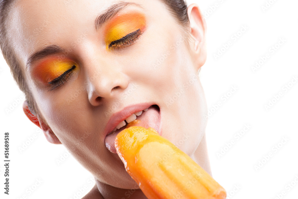 Woman eating orange ice-cream and having fun Woman eating orange ice-cream and having fun