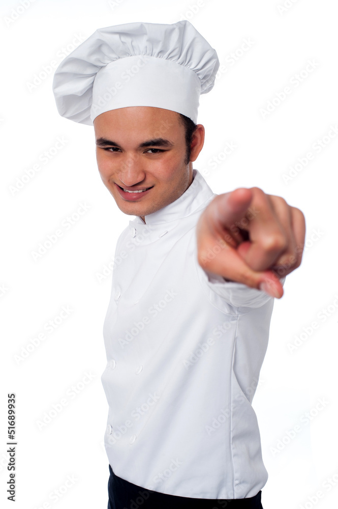 Smart young chef pointing at camera Smart young chef pointing at camera