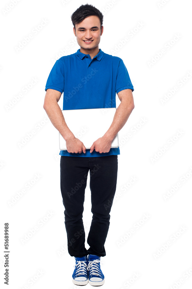 Fototapeta premium Handsome young man holding laptop