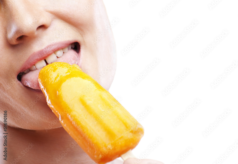 Woman eating orange ice-cream and having fun Woman eating orange ice-cream and having fun