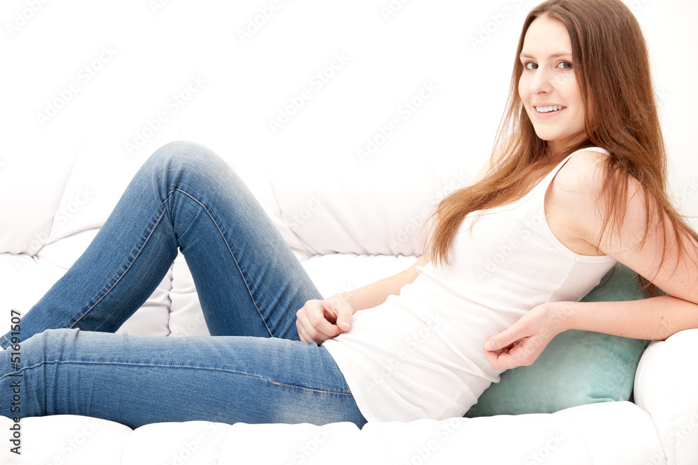 brunette woman lying on the couch in living room