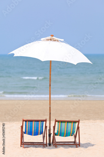 Beach chairs and white umbrella