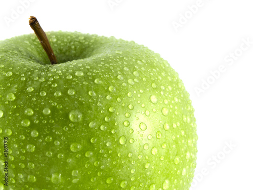 Isolated green apple with water drops on white