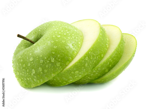 Isolated green apple slices with water drops photo