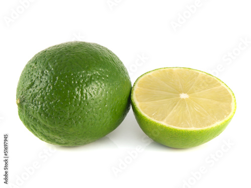 Isolated green lime with sliced half on a white