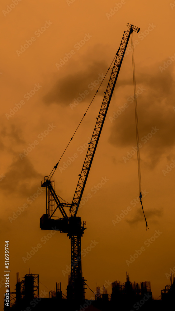 High crane on the top of the construction High crane on the top of the construction