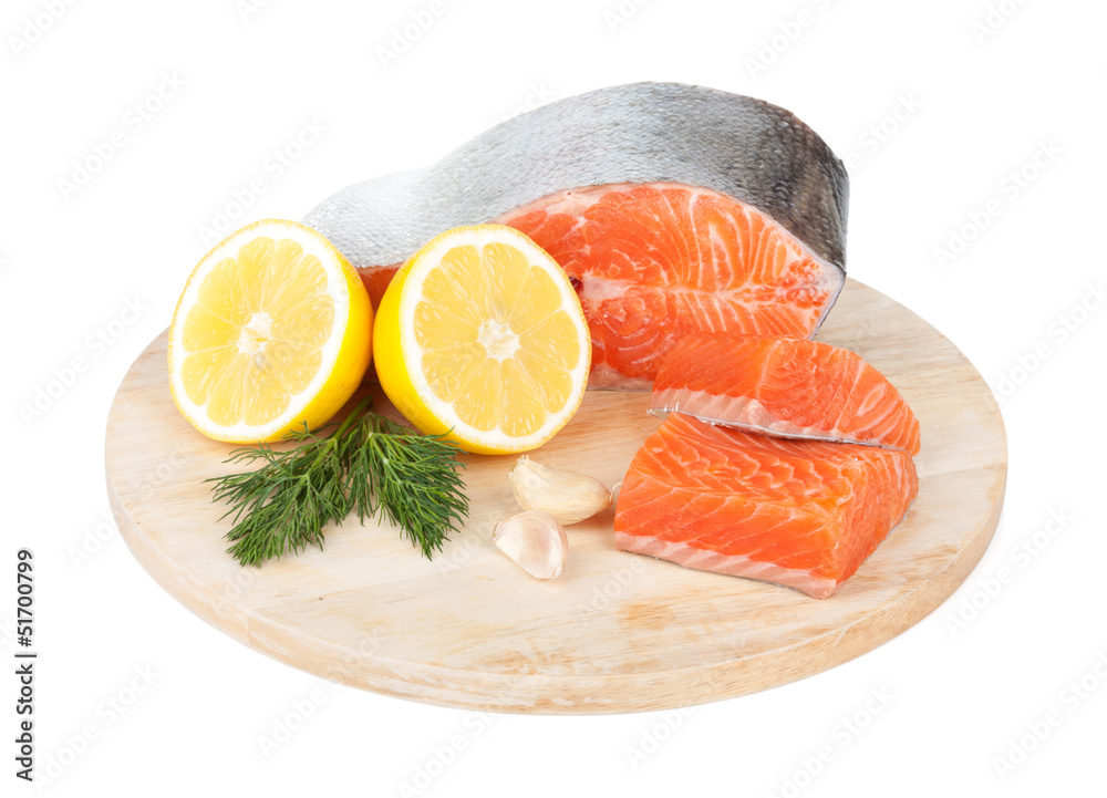 Salmon on cutting board with lemons and herbs Salmon on cutting board with lemons and herbs