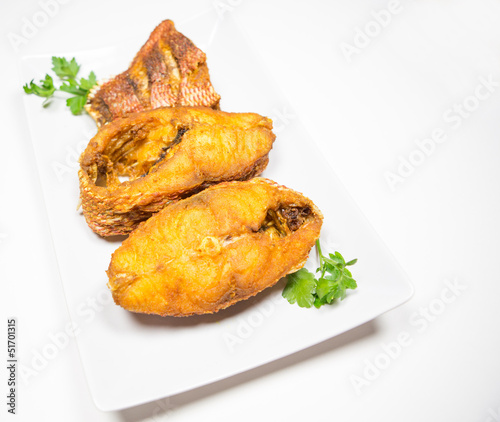 Portions of deep fried red snapper fish.