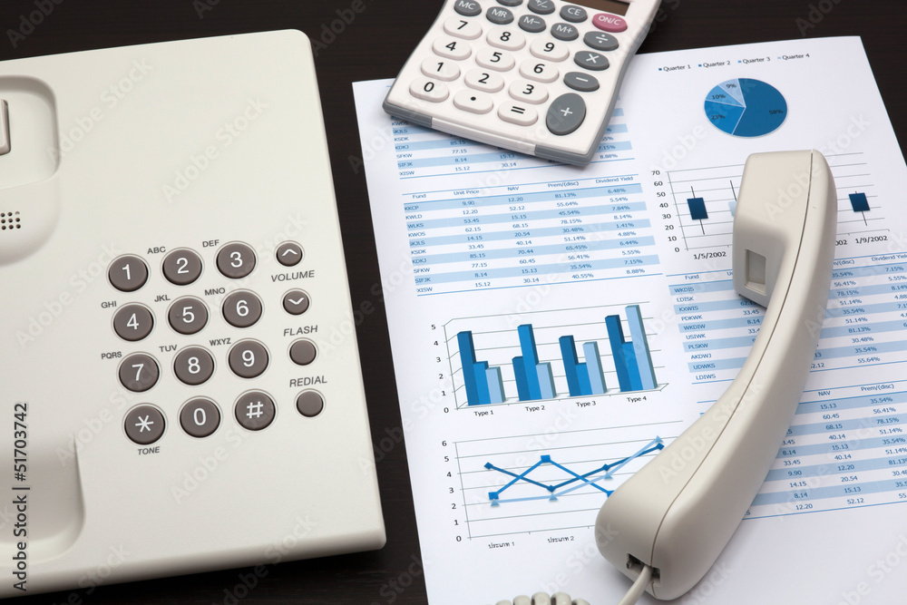 business report with telephone on a table business report with telephone on a table